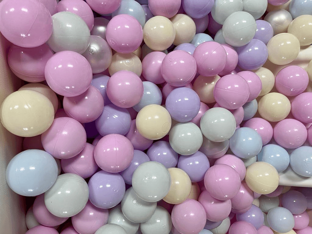 Children's ball bit filled with balls of pastel colours.